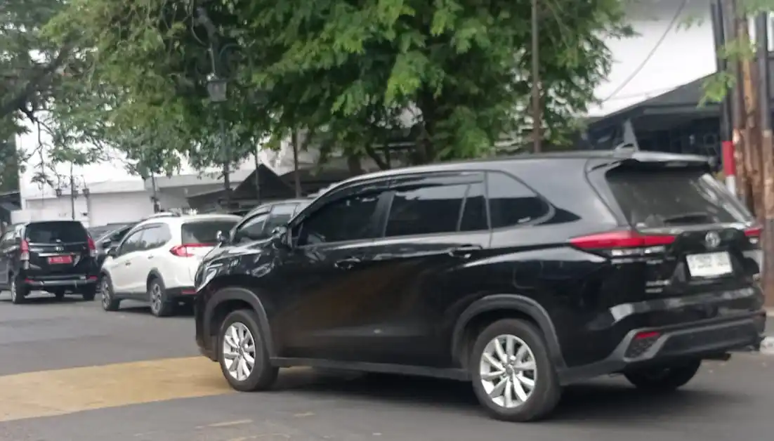 Kendaraan plat merah parkir di bahu jalan dekat kantor Pemkot Bandung, Jawa Barat, Rabu (23/7/2025). (Foto: MI/Sugiyanto)